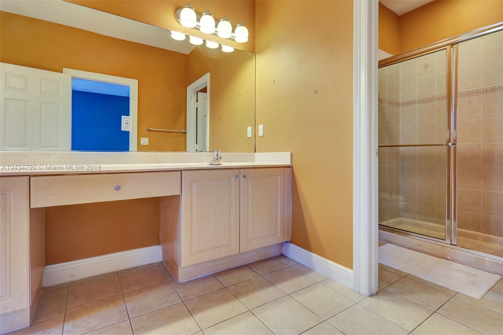2127 Southwest 99th Way Miramar, FL 33025 - Photo 21 of 43 a view of a kitchen with a sink and a mirror