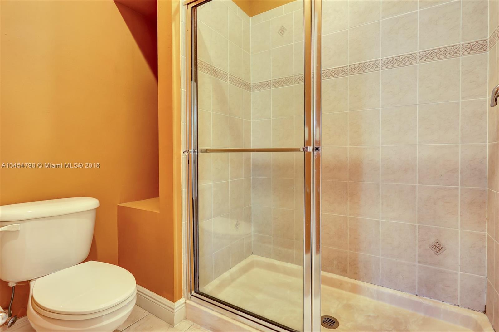 2127 Southwest 99th Way Miramar, FL 33025 - Photo 22 of 43 a bathroom with a shower and a toilet