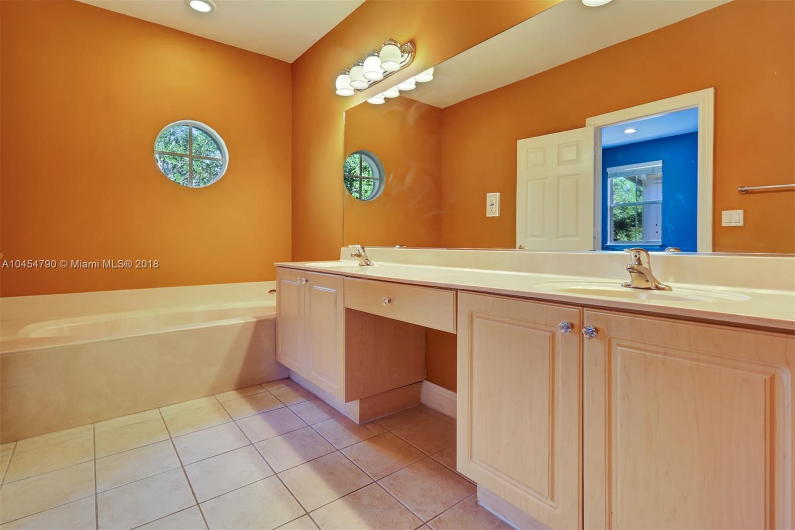 2127 Southwest 99th Way Miramar, FL 33025 - Photo 23 of 43 a bathroom with a sink a tub and a mirror