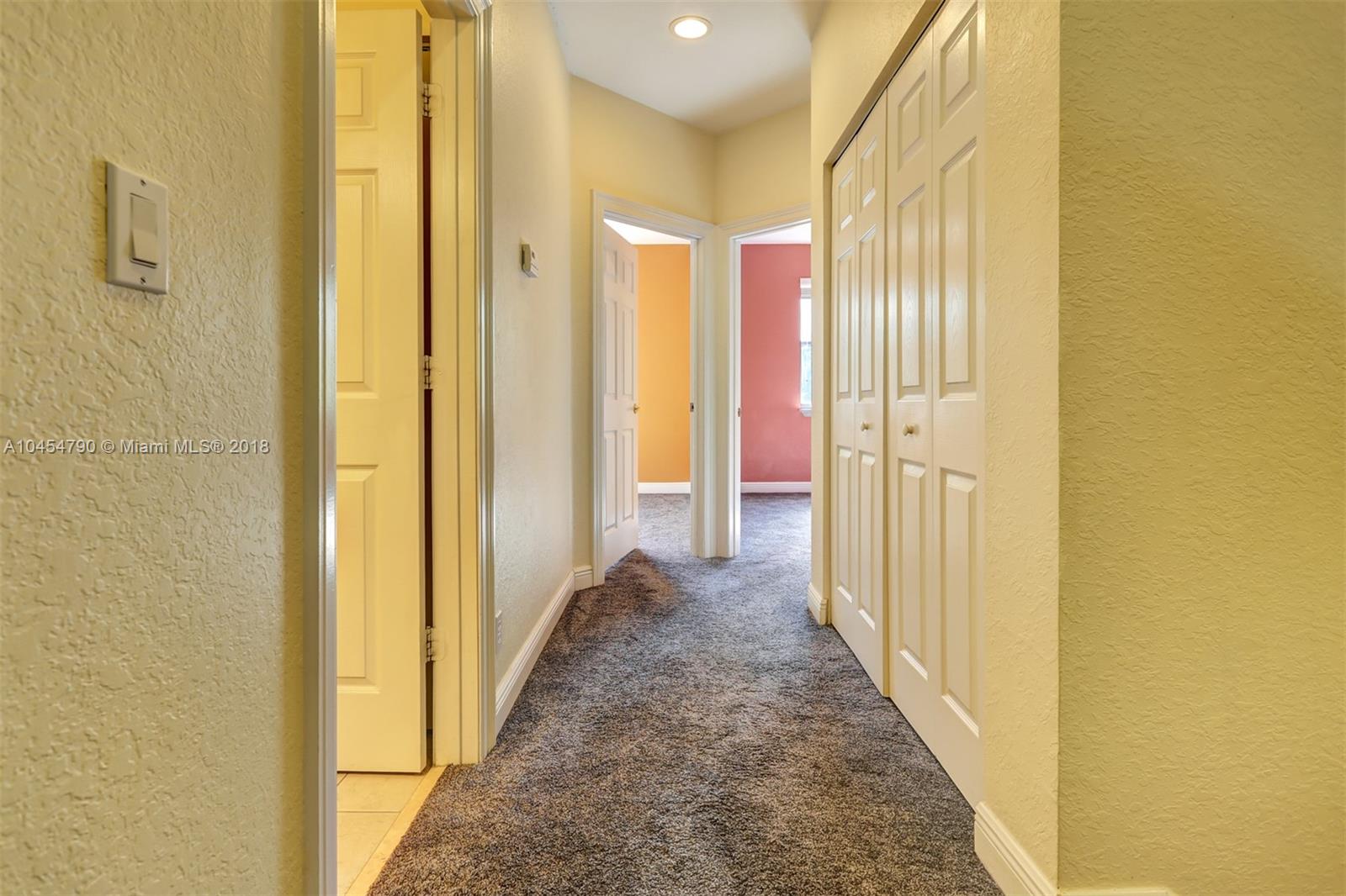 2127 Southwest 99th Way Miramar, FL 33025 - Photo 25 of 43 a view of a hallway with wooden shelves