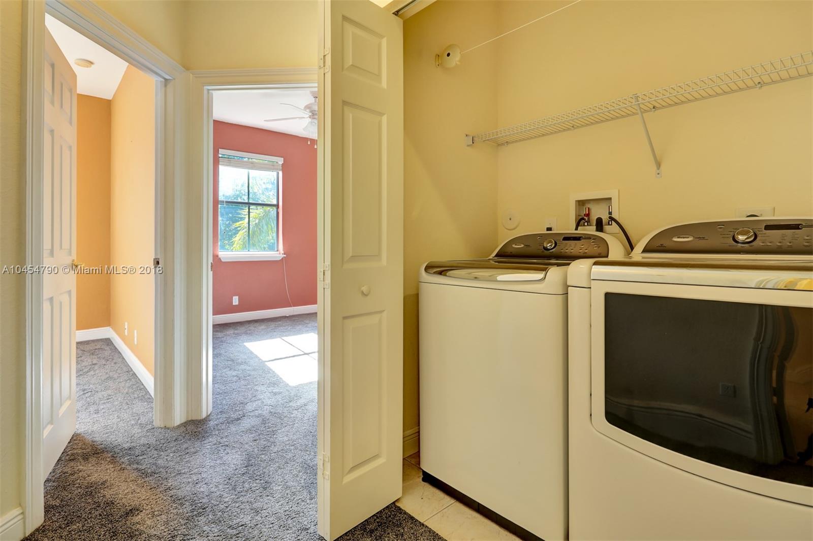 2127 Southwest 99th Way Miramar, FL 33025 - Photo 26 of 43 a utility room with dryer and washer
