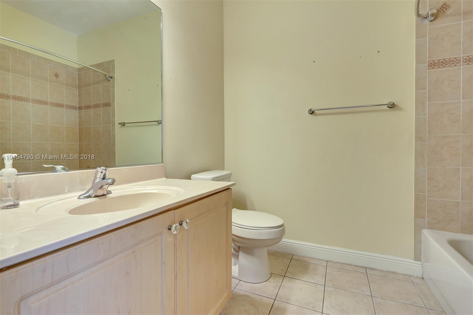 2127 Southwest 99th Way Miramar, FL 33025 - Photo 31 of 43 a bathroom with a sink a toilet and a mirror