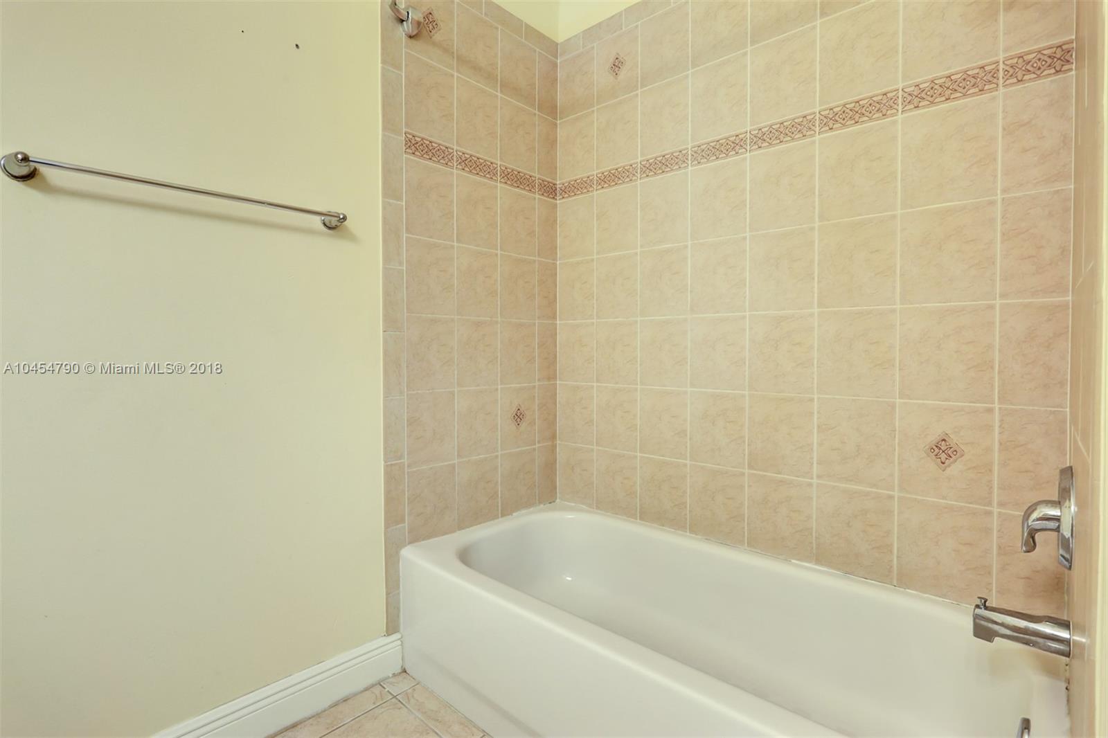 2127 Southwest 99th Way Miramar, FL 33025 - Photo 32 of 43 a bathroom with a bathtub