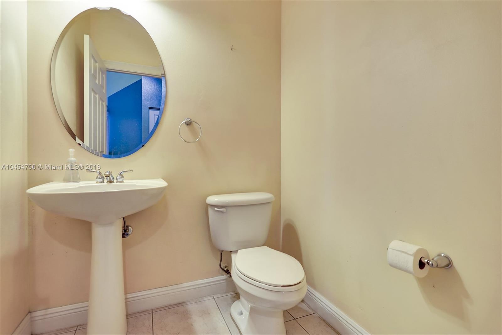 2127 Southwest 99th Way Miramar, FL 33025 - Photo 33 of 43 a bathroom with a sink mirror and toilet