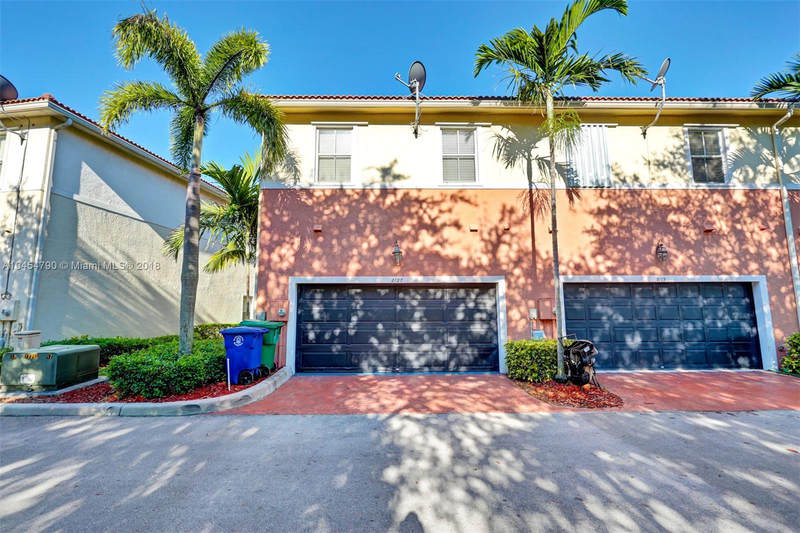 2127 Southwest 99th Way Miramar, FL 33025 - Photo 36 of 43 a front view of a house with a yard and a garage
