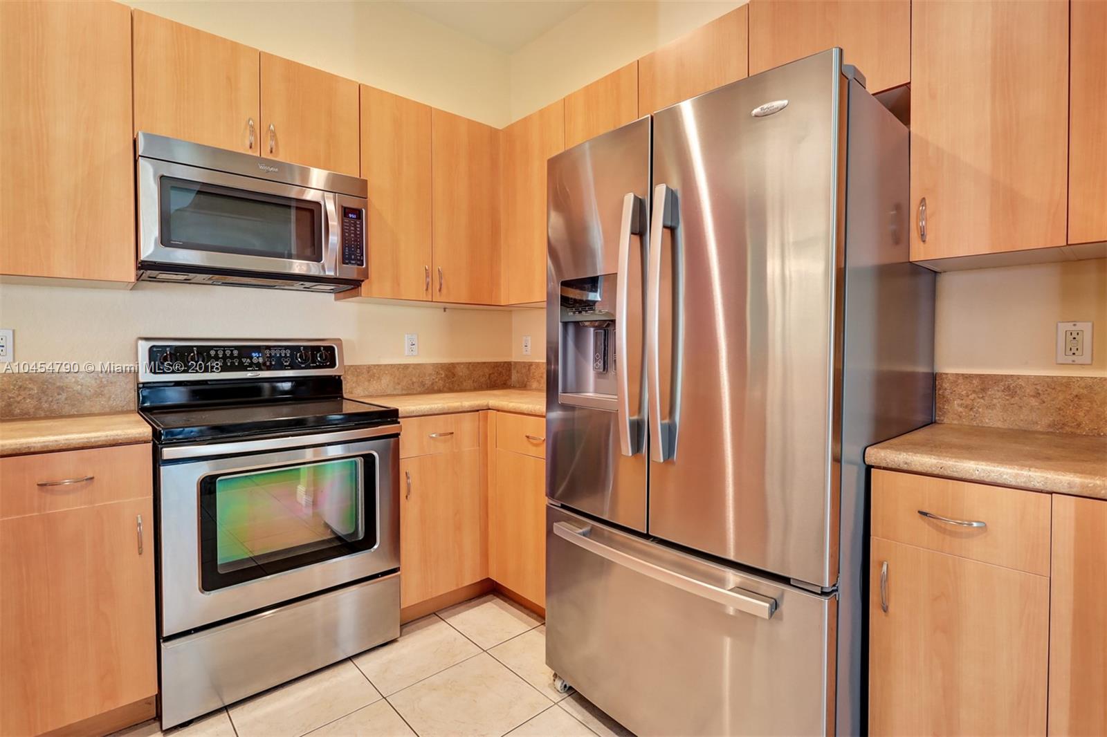 2127 Southwest 99th Way Miramar, FL 33025 - Photo 9 of 43 a kitchen with stainless steel appliances a refrigerator stove and microwave