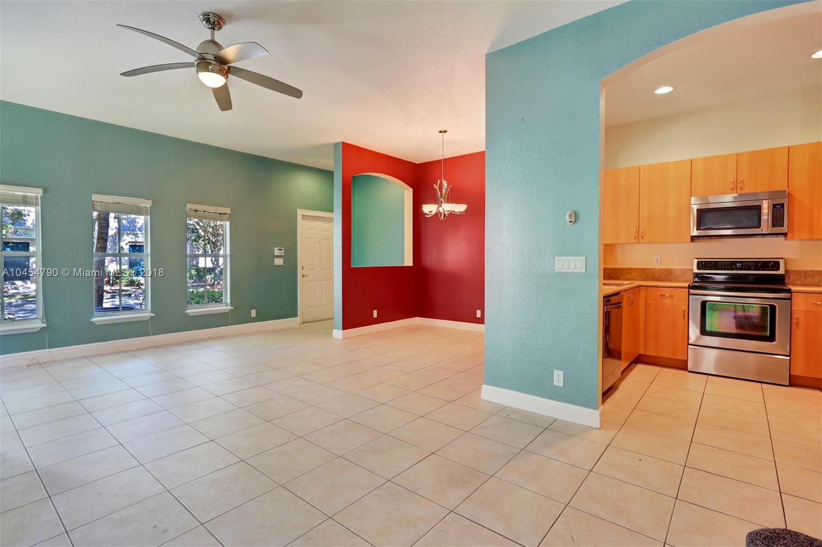 2127 Southwest 99th Way Miramar, FL 33025 - Photo 10 of 43 a kitchen with stainless steel appliances granite countertop a refrigerator and a stove top oven