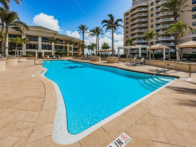 a swimming pool with outdoor seating and yard