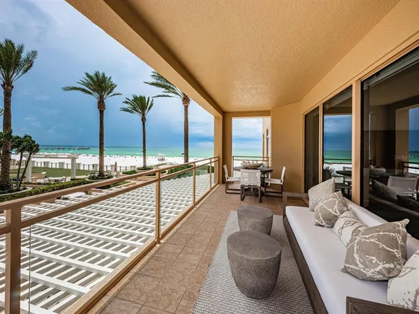 a living room with furniture and floor to ceiling window