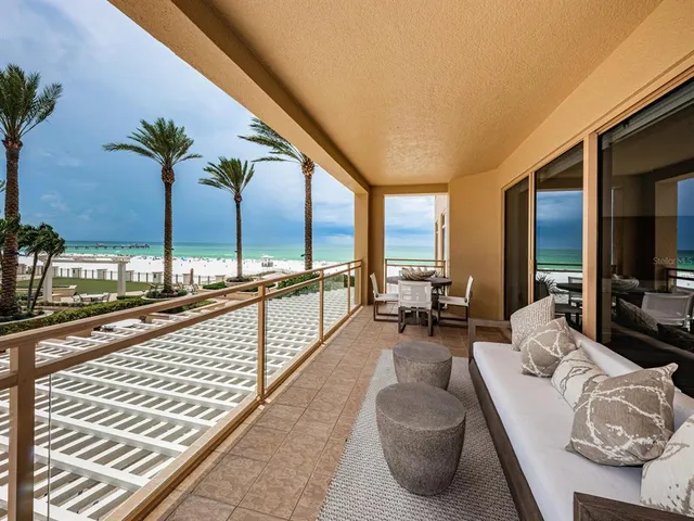 a living room with furniture and floor to ceiling window