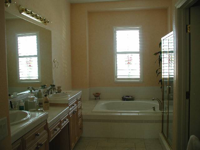 152 Mule Creek Circle Reno, NV 89511 - Photo 7 of 9 a bathroom with a granite countertop sink a large mirror a bathtub and window