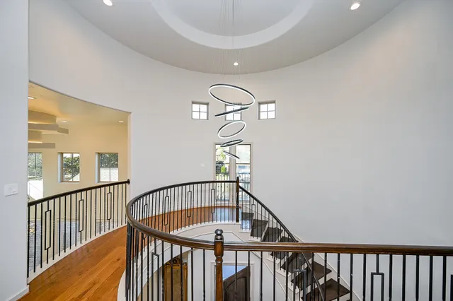 a living room with furniture flat screen tv and a large window