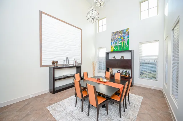 a dining room with furniture and wooden floor