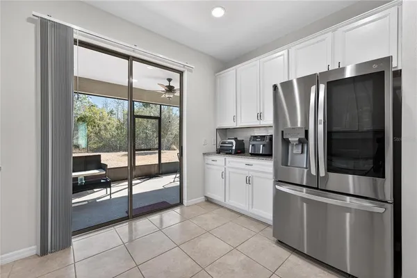 a view of a dining room with furniture a chandelier and wooden floor