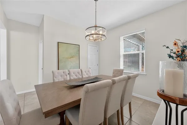 a view of a dining room with furniture wooden floor and a chandelier