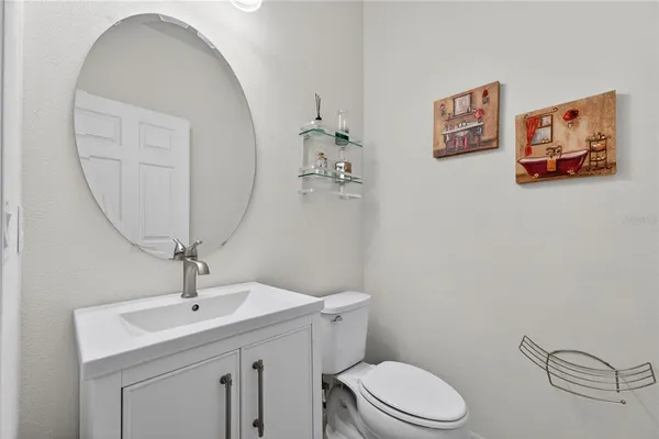 a living room with furniture and a ceiling fan