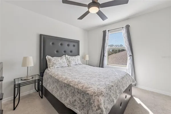 a bathroom with a granite countertop sink mirror vanity and toilet