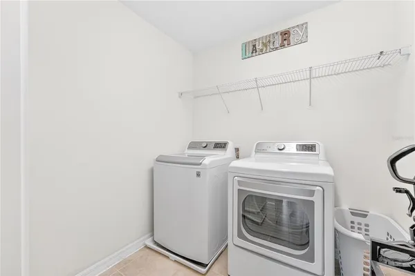 a aerial view of a house with swimming pool and large trees