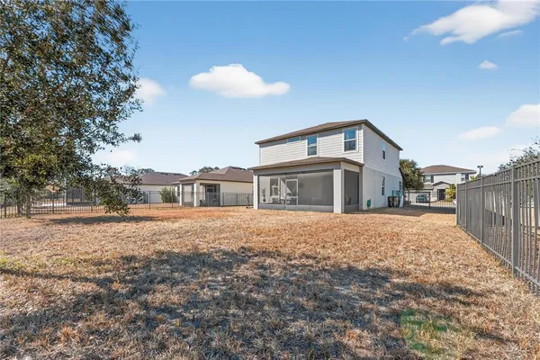 an aerial view of a house with a yard basket ball court and outdoor seating
