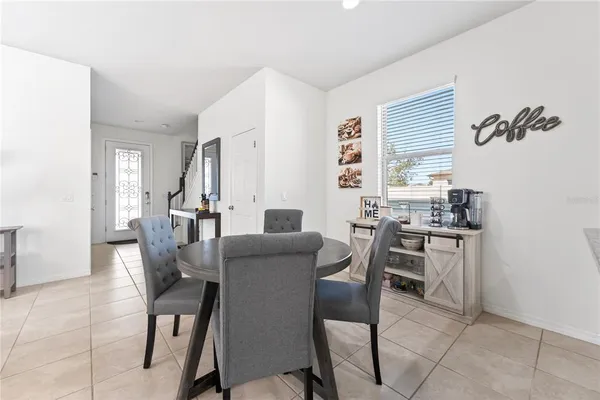 a dining room with furniture and window