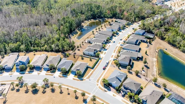 an aerial view of a house with a yard and garden