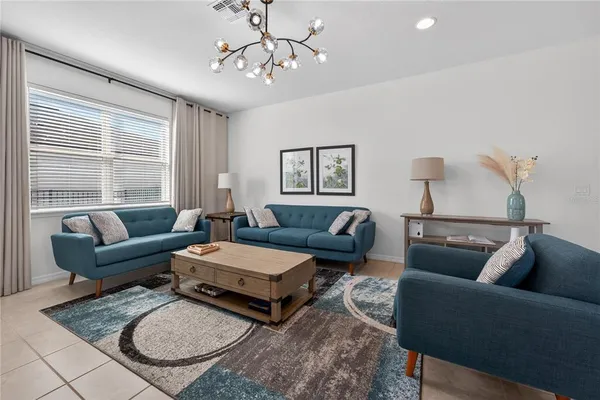 a living room with furniture a rug and a window