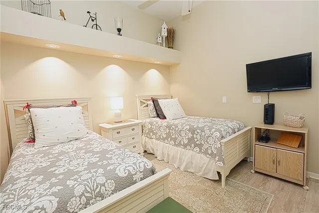 a bedroom with a bed and flat screen tv