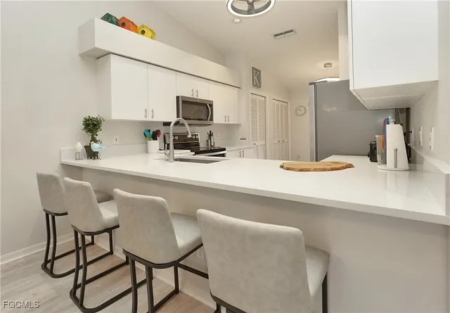 a living room with fireplace furniture and a chandelier