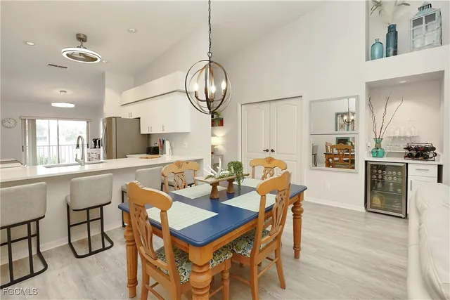 a room with a balcony a bed and a dresser next to a window