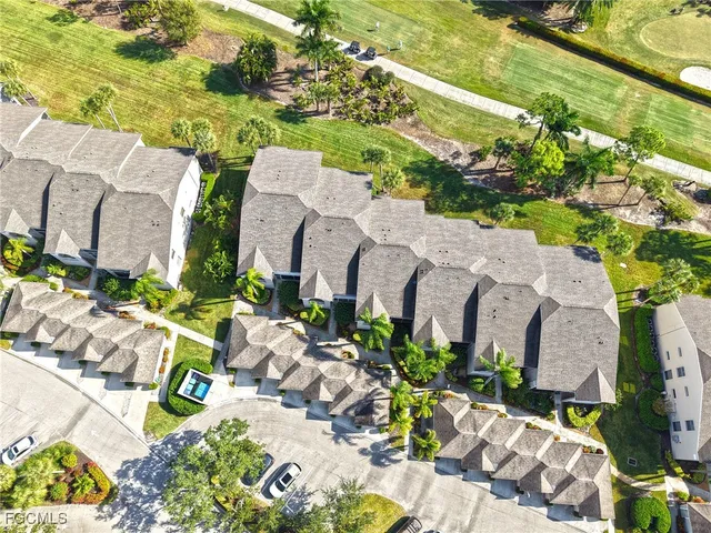 an aerial view of a house with a yard and garden