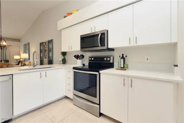 a kitchen with stainless steel appliances a refrigerator sink and cabinets