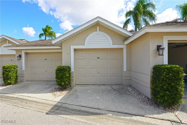 an aerial view of a house with outdoor space and seating area