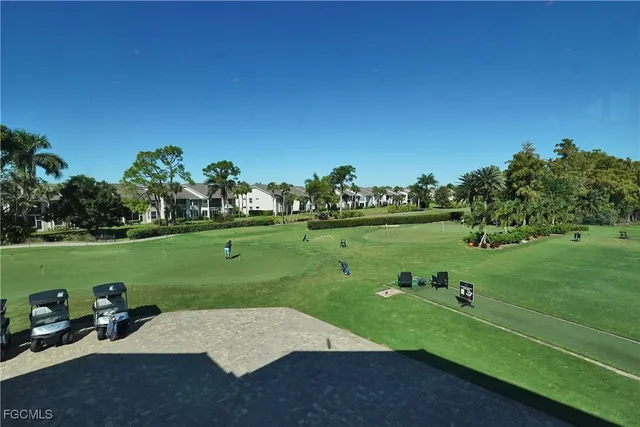 a room with lots of furniture and view of kitchen appliances