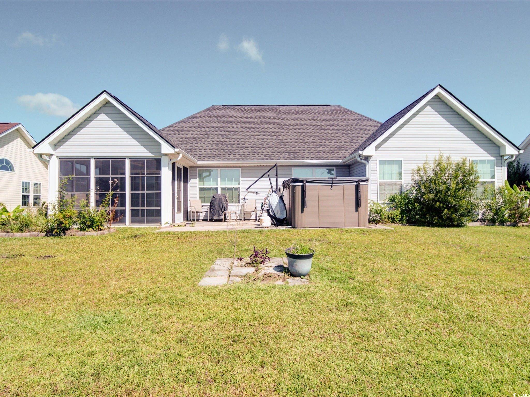 708 Shenanigan Loop Murrells Inlet, SC 29576 - Photo 6 of 20 Back of property featuring a sunroom, a yard, a pa