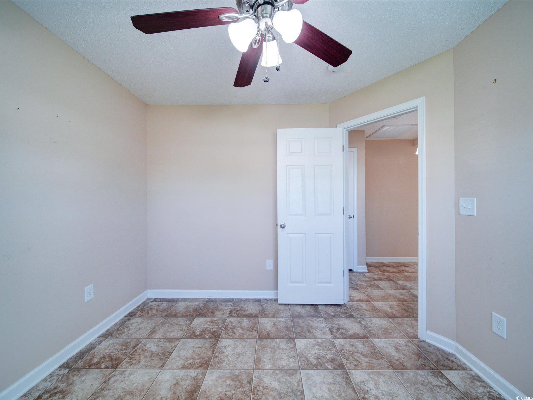 708 Shenanigan Loop Murrells Inlet, SC 29576 - Photo 8 of 20 Empty room with ceiling fan and baseboards