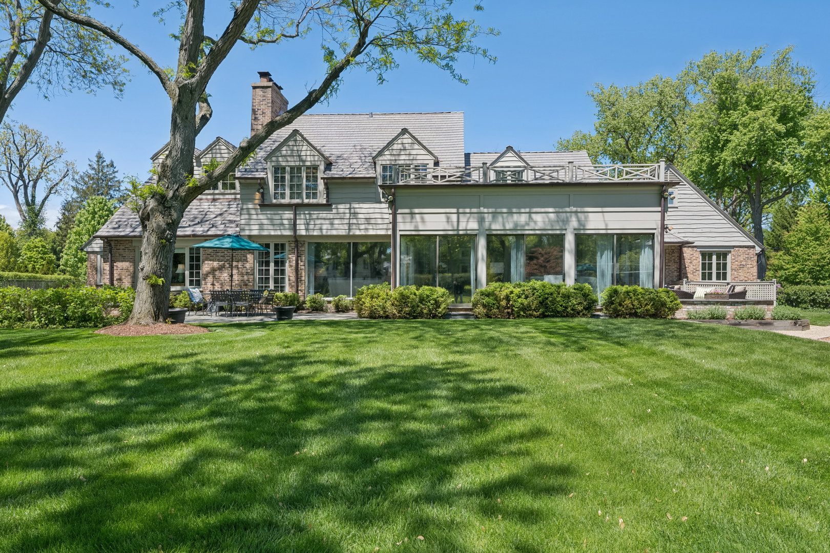 936 Sunset Road Winnetka, IL 60093 - Photo 26 of 50 a front view of a house with a yard table and chairs