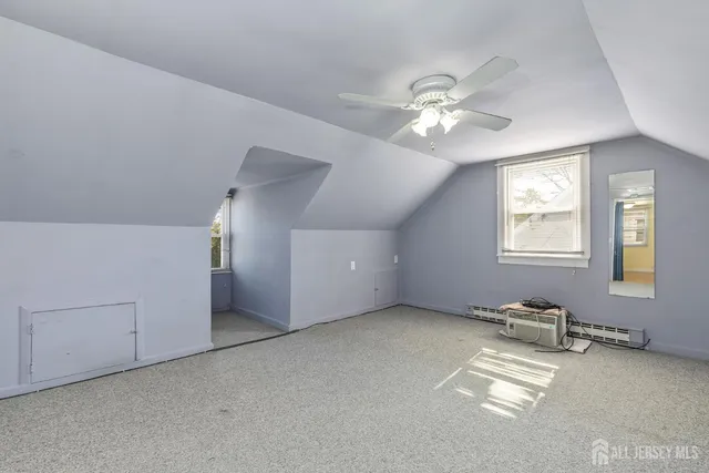 a view of a livingroom with a ceiling fan and window