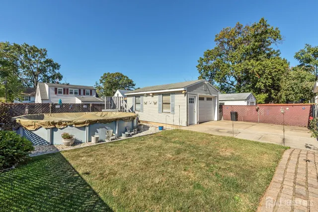 a view of a house with pool and chairs