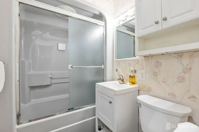 a bathroom with a sink toilet and shower