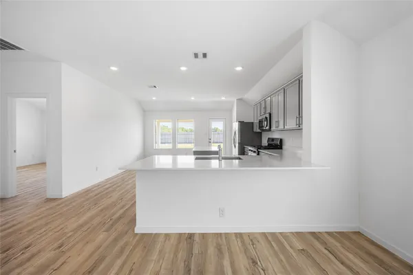 a view of kitchen with cabinets and wooden floor