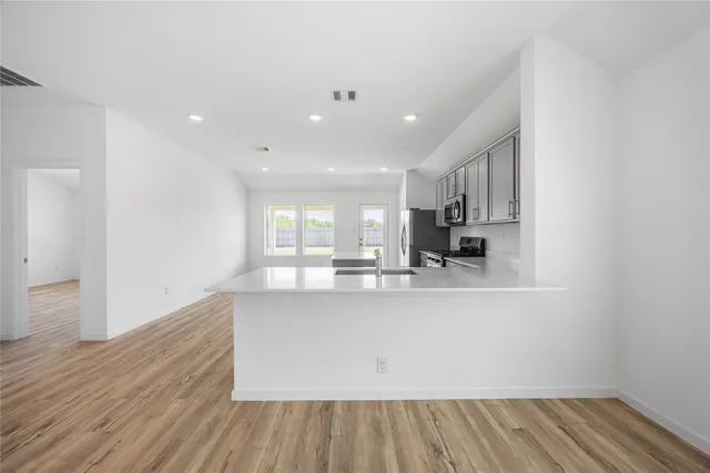 a view of kitchen with cabinets and wooden floor