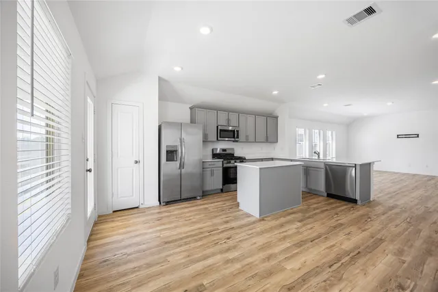 a kitchen with a refrigerator and a sink