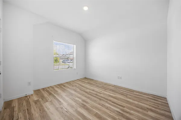 a view of a room with wooden floor and closet