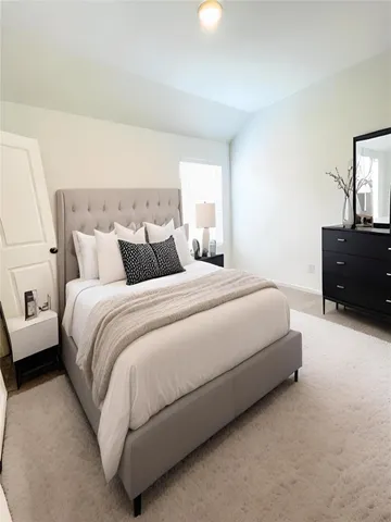 a bedroom with a bed and window