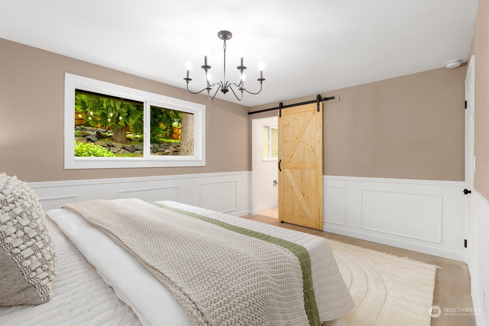 212 143rd Street Southeast Everett, WA 98208 - Photo 18 of 40 a spacious bedroom with a bed and a chandelier