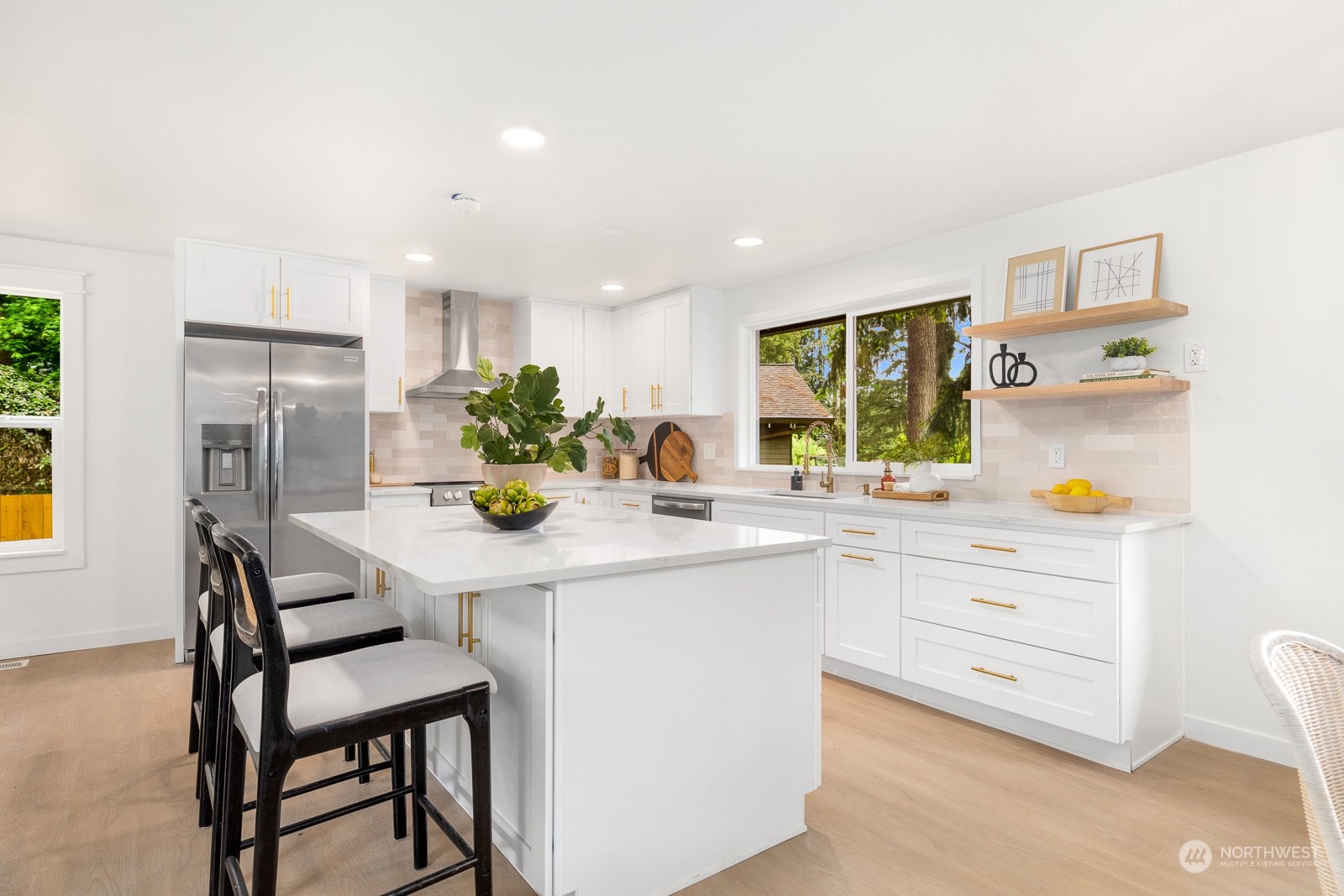 212 143rd Street Southeast Everett, WA 98208 - Photo 9 of 40 a kitchen with stainless steel appliances kitchen island granite countertop a table chairs and a refrigerator