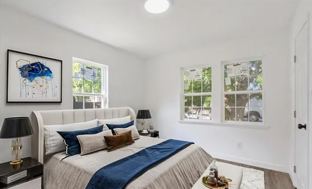 a bedroom with bed and a window