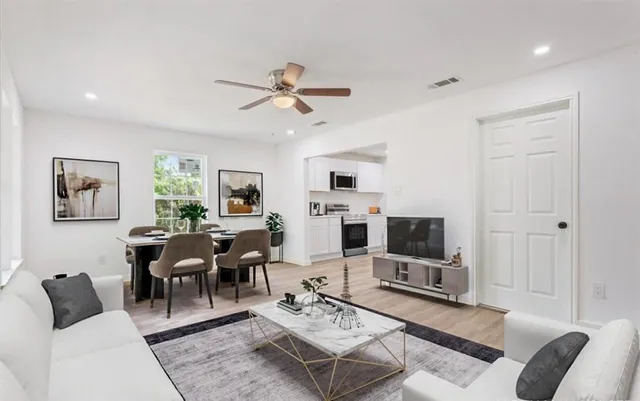 a living room with furniture a rug and a flat screen tv