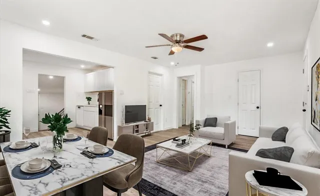 a living room with furniture and view of kitchen