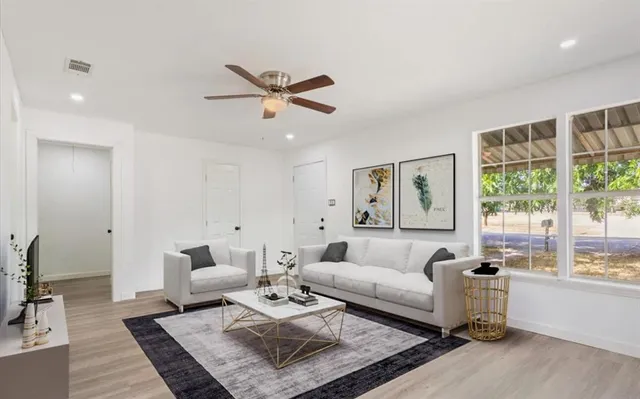 a living room with furniture and a large window